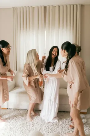 Wedding photo: bride bridesmaids champagne toast robes