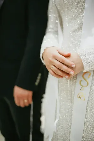 Wedding photo: bride ringed hands sequined dress