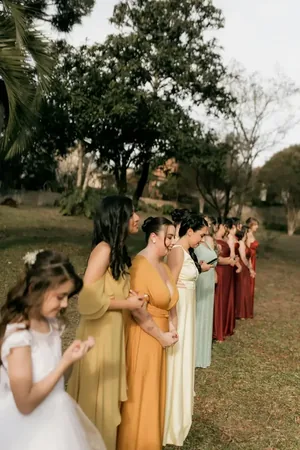 Wedding photo: bridesmaids colorful gowns lineup outdoors