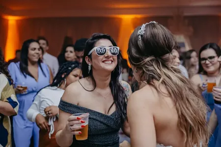 Wedding photo: guest fun glasses talking to bride