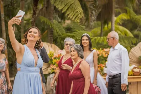 Wedding photo: guest selfie tropical outdoor ceremony