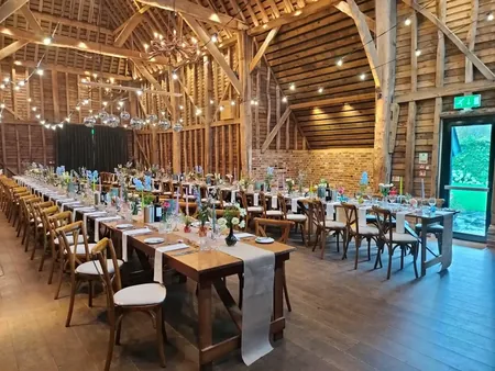 Wedding photo: rustic barn reception string lights